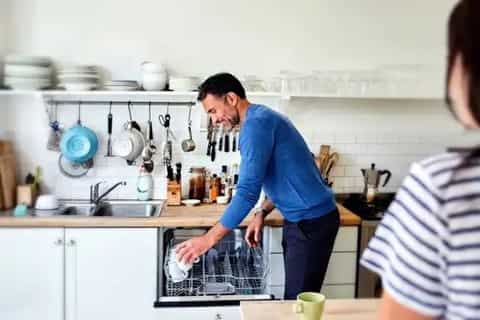 A Man Using the Dishwasher